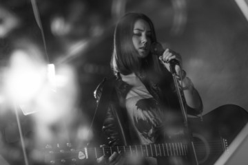 the girl playing guitar in the Studio