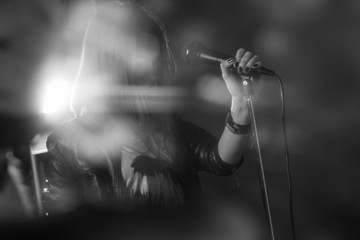 girl singing into a microphone in a studio