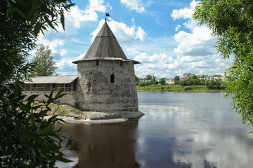Fototapeta na wymiar Old tower on the river bank