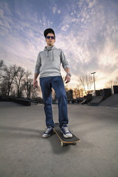 Portrait of cool skater boy in a skate park