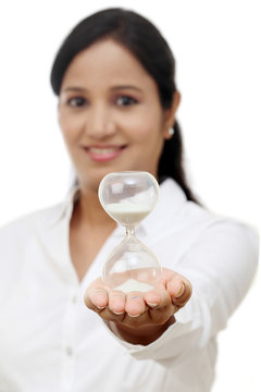 Business woman holding hourglass