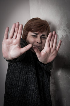Scared and abused woman with stretched arms