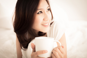 Portrait of a beautiful young woman in bed