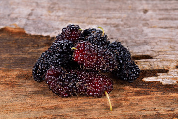 mulberry isolated on wood background