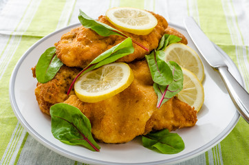 Fried schnitzel with herbs and lemon