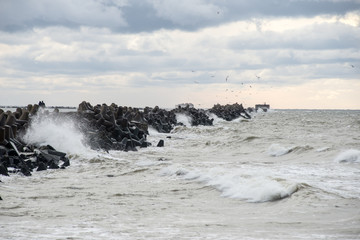 waves crushing over rocks in sunset