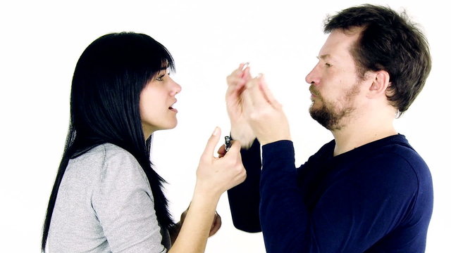 Man breaking cigarette to woman imposing her to quit smoking.