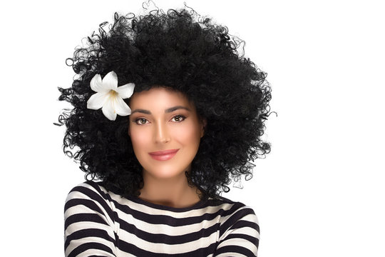 Fashion Brunette Girl with Flower in Curly Afro Hairstyle