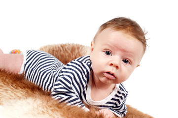 Portrait of adorable baby boy lying on fur