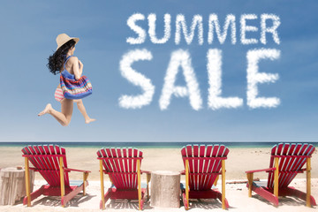 Lady at beach with summer sale cloud