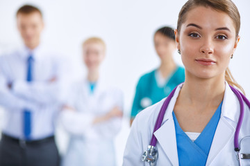 Fototapeta premium Woman doctor standing with stethoscope at hospital