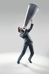 Wandcirkels aluminium Elegant man yelling over the huge megaphone © konradbak