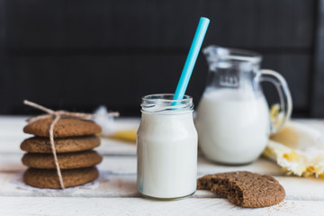 Rustic home made cookies on the wooden background with milk