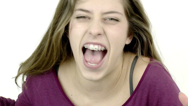 Sad desperate female teenager screaming isolated closeup