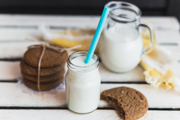 Rustic home made cookies on the wooden background with milk