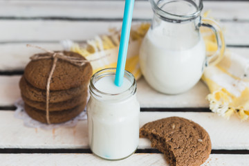 Rustic home made cookies on the wooden background with milk