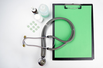 Medical clipboard and stethoscope isolated on white background.