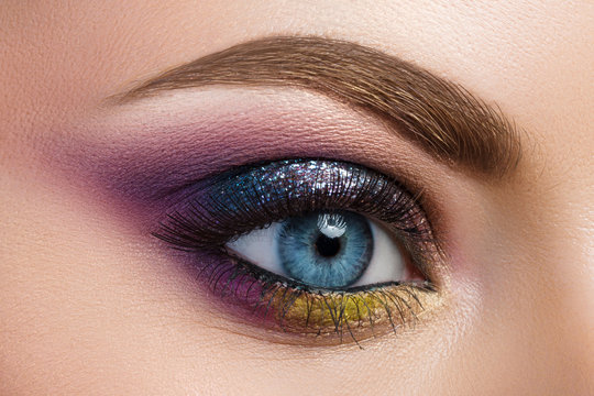 Close-up view of blue female eye with beautiful modern creative