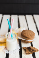Rustic home made cookies on the wooden background with milk