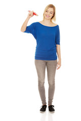 Young woman writing with pencil.