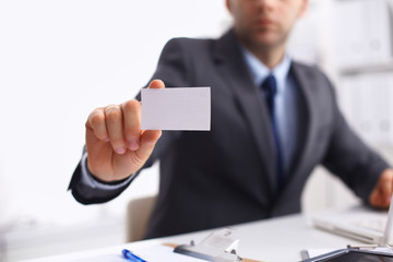 Man's hand showing white  business card