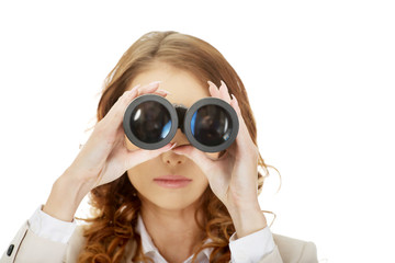 Businesswoman looking through binoculars.