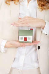 Businesswoman presenting a model house.