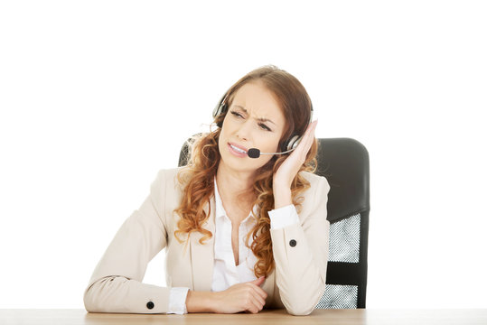 Irritated call center woman by a desk.