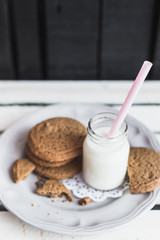 Rustic home made cookies on the wooden background with milk