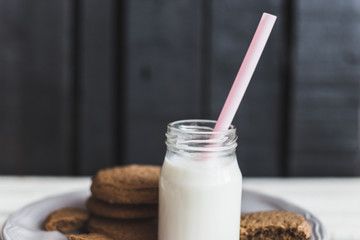 Rustic home made cookies on the wooden background with milk