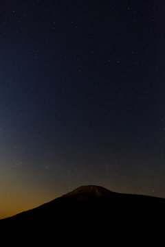 Starry sky on a background of mountain peaks.