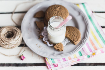 Rustic home made cookies on the wooden background with milk