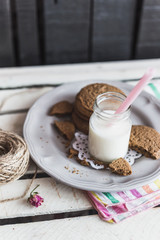 Rustic home made cookies on the wooden background with milk