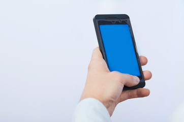 man's hand holding cell phone with empty blue screen
