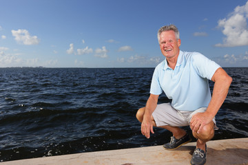 Man squatting by the water