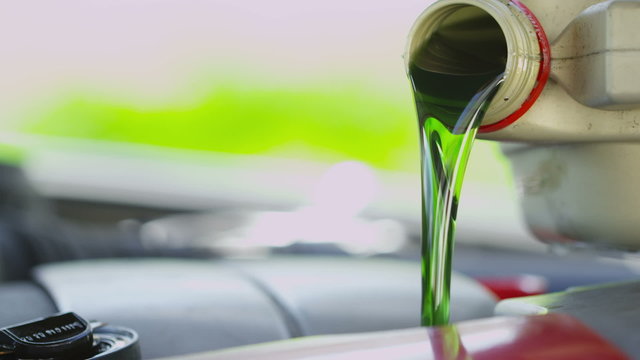 Fresh oil being poured into a car engine