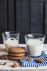 Rustic home made cookies on the wooden background with milk