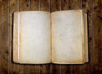 Open old blank book on wooden table