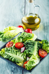 Fresh lettuce salad with cherry tomatoes  radish and carafe with