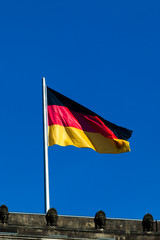 Silky flag of Germany flying in the wind.  German flag on the to