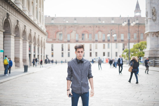 young handsome alternative dark model man in town listening to m