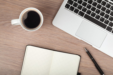 Notepad, laptop and coffee cup