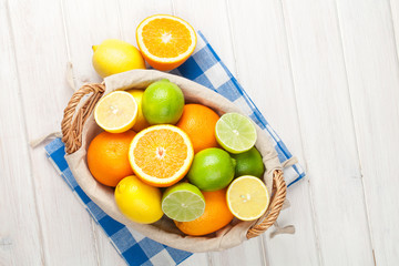 Citrus fruits in basket. Oranges, limes and lemons