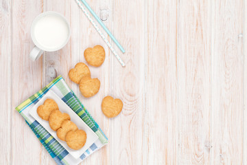 Fototapeta na wymiar Cup of milk and heart shaped cookies