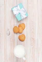Cup of milk, heart shaped cookies and gift box