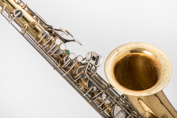 Old saxophone isolatedd  in white background.