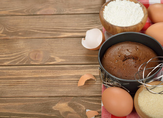 Chocolate cake and ingredients for baking