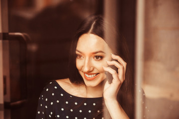 Fototapeta premium Beautiful girl works with technologise on the phone