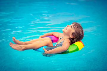 Child playing in swimming pool