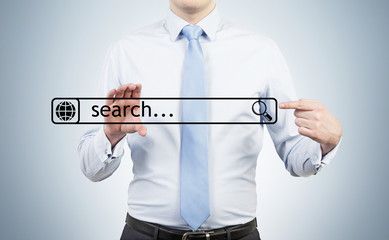 Businessman is holding the internet search bar in their hands.